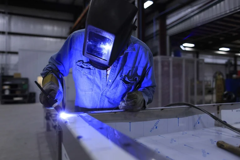 A fabricator welding stainless steel equipment